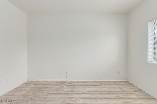 unfurnished room featuring a wealth of natural light and light wood-type flooring