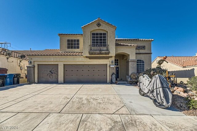 mediterranean / spanish-style home featuring a garage