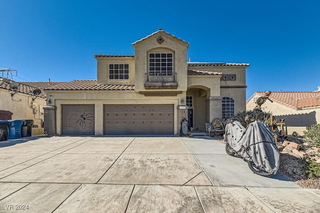 mediterranean / spanish-style house featuring a garage