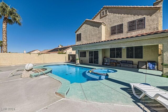 view of pool with an in ground hot tub and a patio