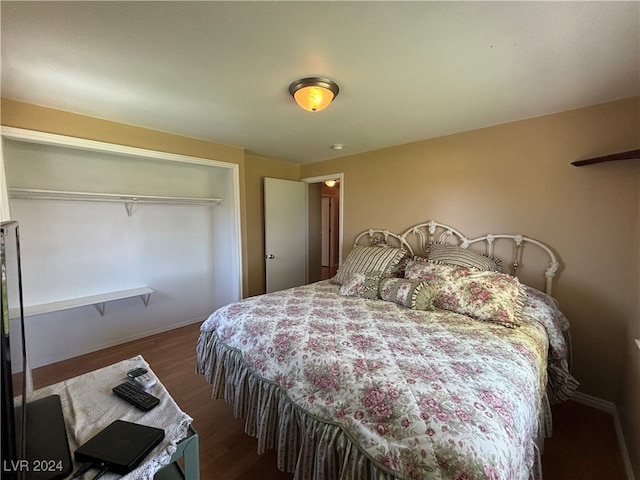 bedroom with dark hardwood / wood-style floors and a closet