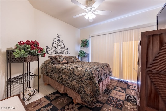 tiled bedroom with ceiling fan