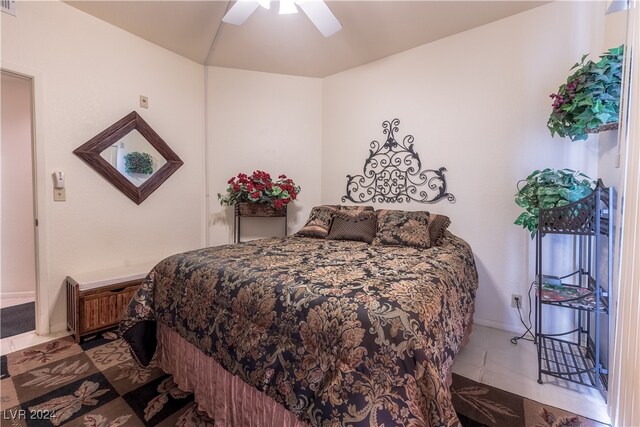 tiled bedroom with ceiling fan