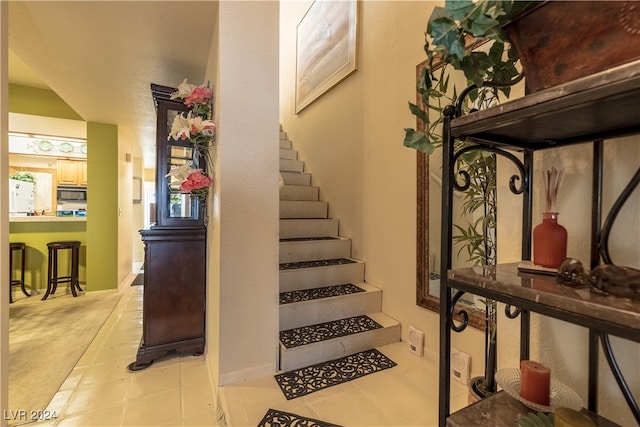 staircase with tile patterned flooring