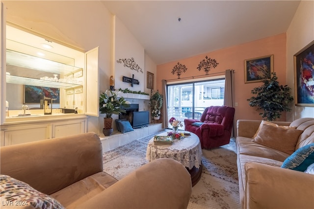 living room with lofted ceiling and a fireplace