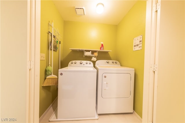 clothes washing area with separate washer and dryer