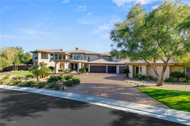 31 Eagles Landing Ln, Las Vegas, NV 89141 - view of front facade featuring decorative driveway, a garage, a front lawn, and stucco siding