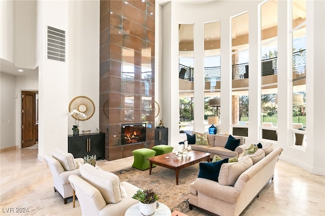 31 Eagles Landing Ln, Las Vegas, NV 89141 - tiled living room with a towering ceiling, a premium fireplace, and recessed lighting