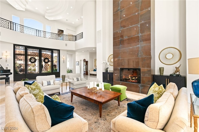 interior space featuring a high ceiling and a tiled fireplace