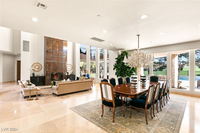 dining space with a chandelier and a fireplace