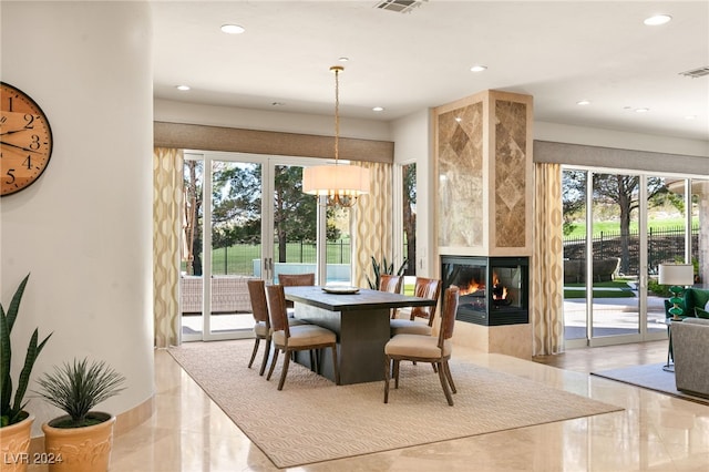 31 Eagles Landing Ln, Las Vegas, NV 89141 - dining room with recessed lighting, a tile fireplace, a chandelier, and marble tiled floors