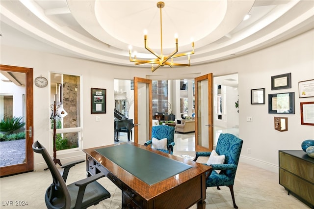 office area with french doors, a notable chandelier, plenty of natural light, and a raised ceiling