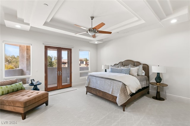 bedroom featuring french doors, a tray ceiling, access to outside, and ceiling fan