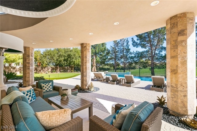 view of patio featuring a fenced in pool and an outdoor living space