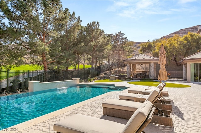 view of pool featuring a gazebo, a mountain view, pool water feature, and a patio