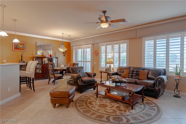 tiled living room with ceiling fan and ornamental molding