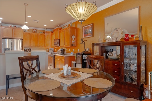 dining room featuring crown molding and light tile patterned floors