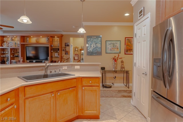 kitchen with hanging light fixtures, sink, stainless steel fridge with ice dispenser, crown molding, and light tile patterned flooring