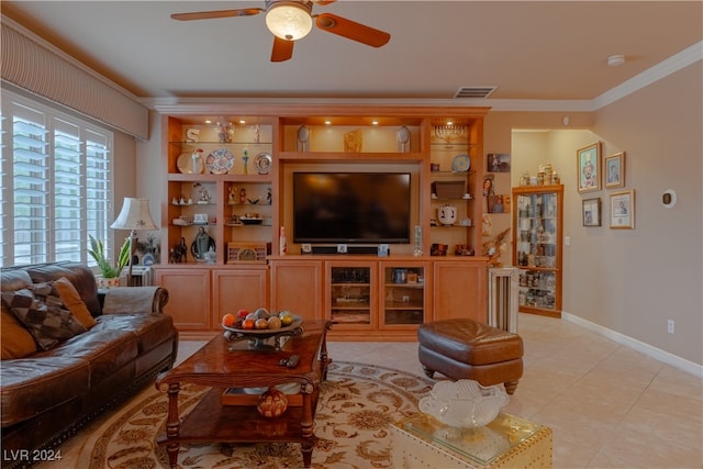 living room featuring ornamental molding, light tile patterned flooring, and ceiling fan