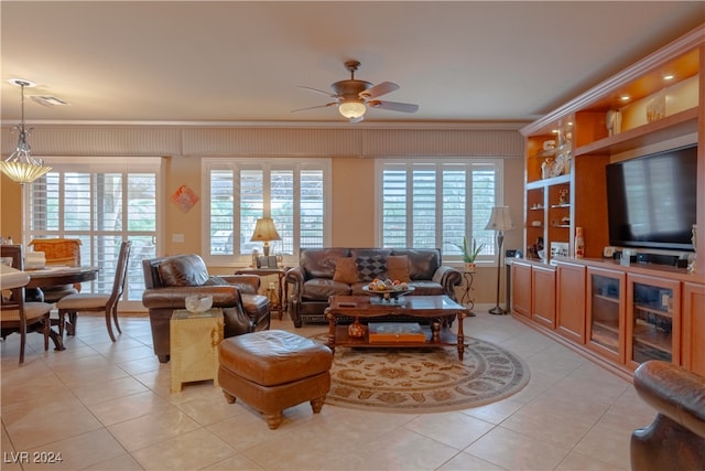 living room featuring ceiling fan, a healthy amount of sunlight, and ornamental molding