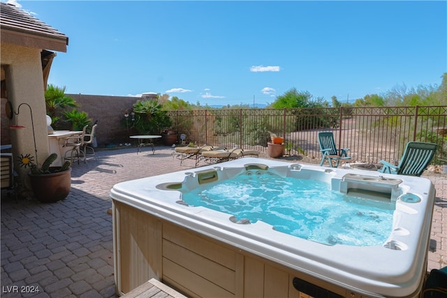 view of swimming pool with a hot tub and a patio area