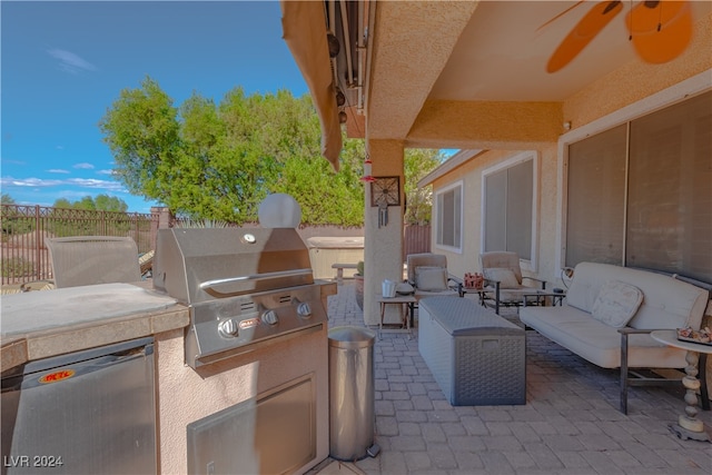 view of patio / terrace featuring ceiling fan, an outdoor living space, grilling area, and exterior kitchen