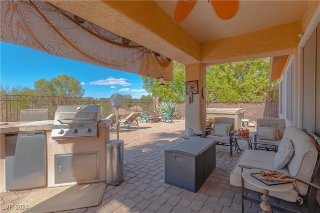 view of patio / terrace featuring exterior kitchen and a grill