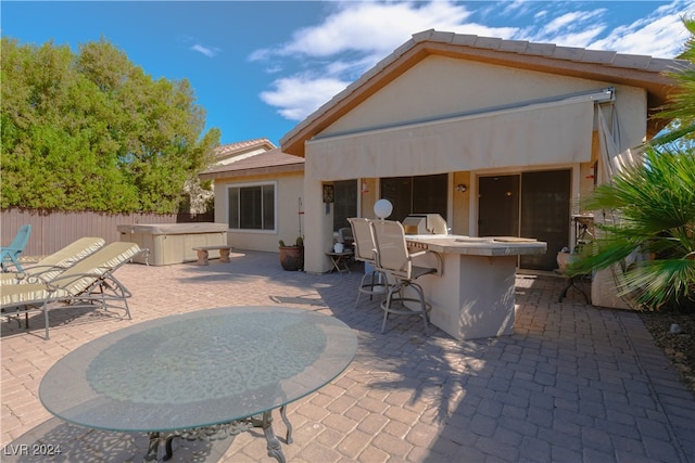 back of house with a patio area and exterior bar