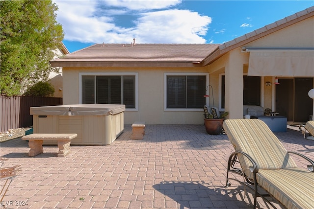 back of house featuring a hot tub and a patio area