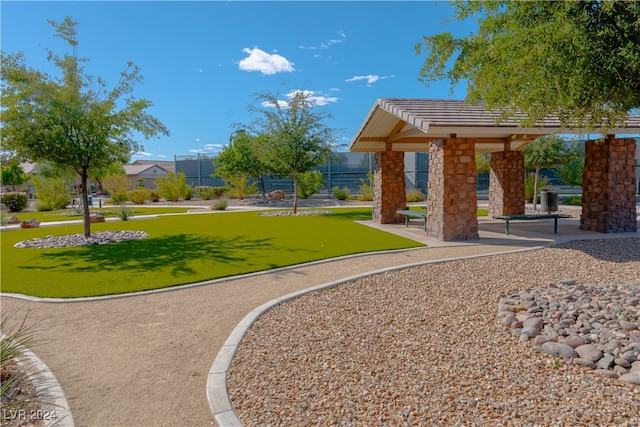 view of property's community with a lawn