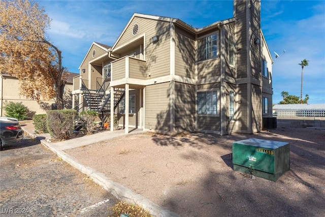 exterior space with stairs and central AC unit