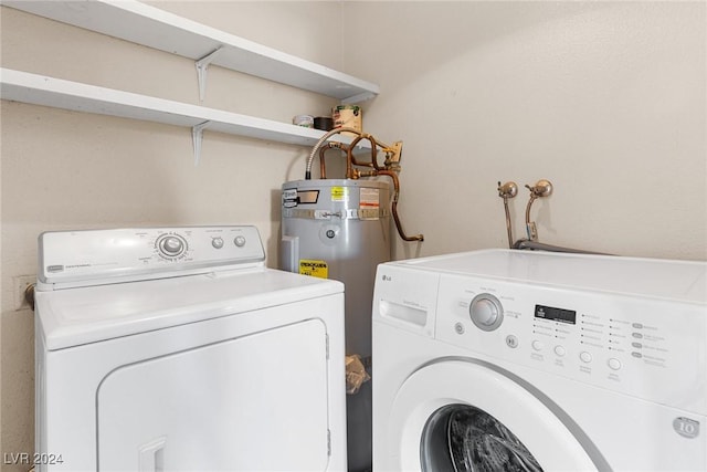 laundry room with laundry area, water heater, and washer and clothes dryer