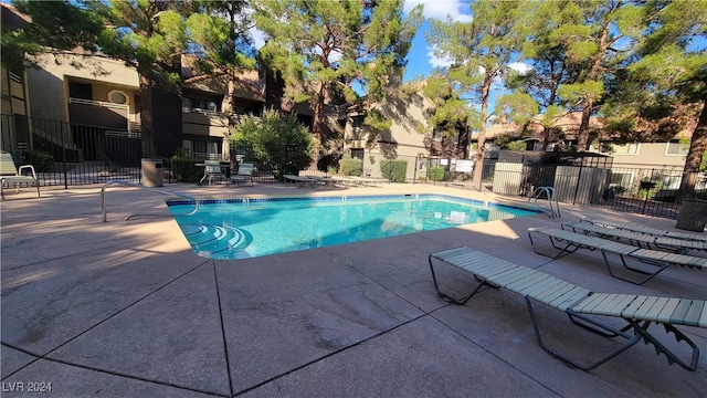 view of swimming pool with a patio area