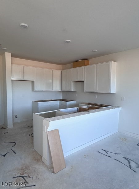 kitchen with white cabinets and a center island