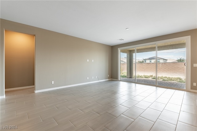 empty room featuring visible vents and baseboards