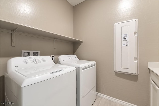 washroom with laundry area, independent washer and dryer, and baseboards