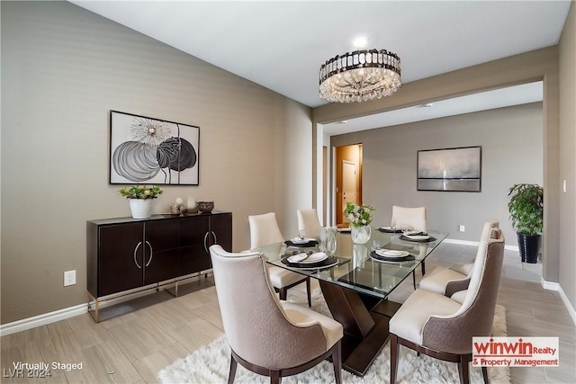 dining space featuring light wood-style flooring and baseboards