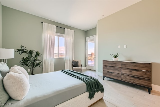 bedroom with light wood-type flooring and access to outside