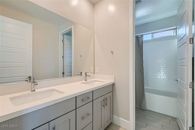 bathroom featuring vanity, hardwood / wood-style flooring, and shower / bath combo