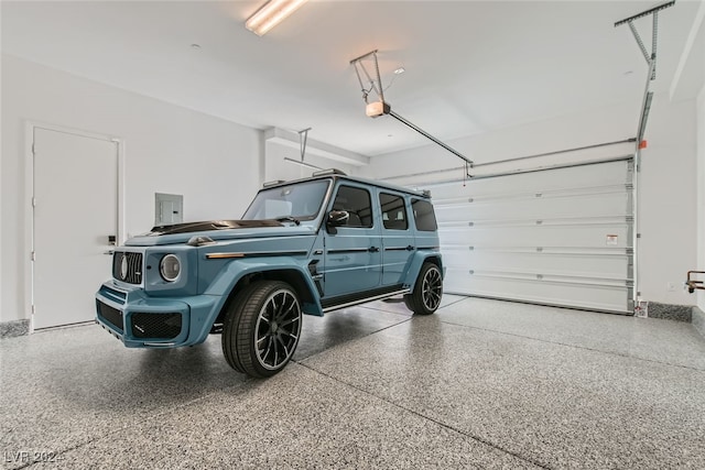 garage with a garage door opener and electric panel