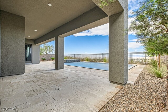 view of patio featuring a fenced in pool