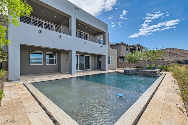 view of swimming pool featuring a patio area and an in ground hot tub