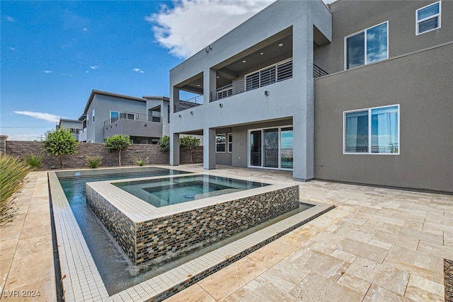 view of pool with a patio and an in ground hot tub