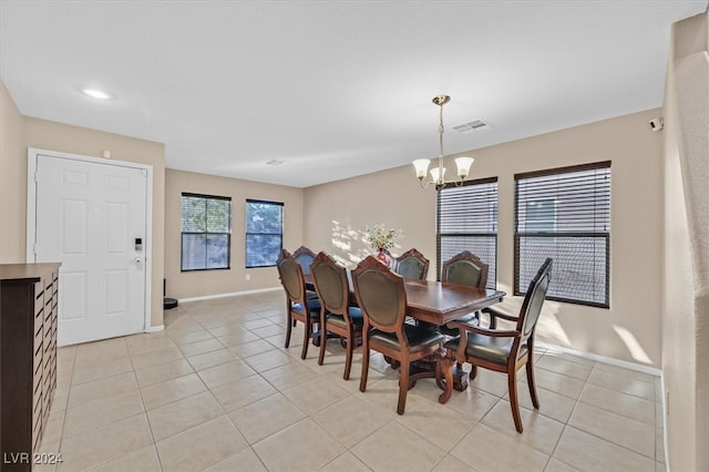 tiled dining area featuring a notable chandelier