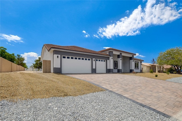 prairie-style home with a front yard and a garage