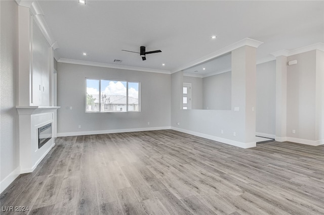 unfurnished living room with ornamental molding, light wood-type flooring, and ceiling fan