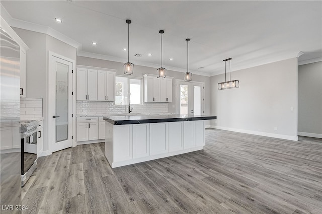 kitchen featuring a kitchen island, pendant lighting, light wood-type flooring, stainless steel range with electric cooktop, and white cabinets