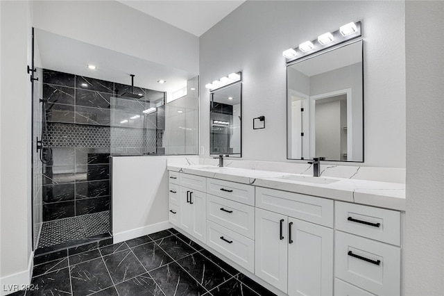 bathroom with vanity and tiled shower