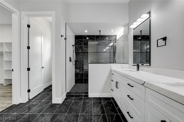 bathroom with vanity and tiled shower