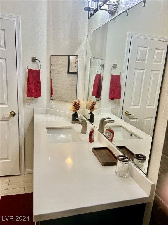 bathroom with vanity, tile patterned flooring, and a notable chandelier